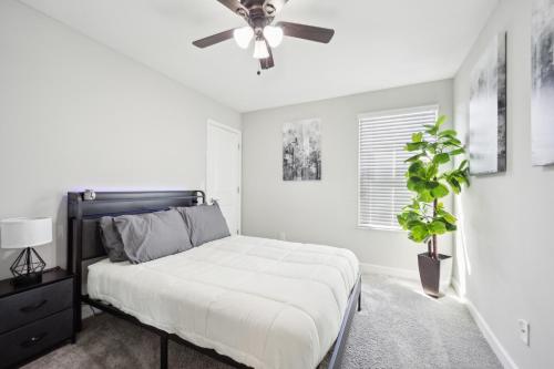a bedroom with a bed and a ceiling fan at Tampa Private Home Game Room Theater Room & more in Riverview