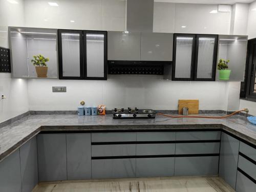 a kitchen with white cabinets and a counter top at Luxurious 2 BHK Apartment - Home away from Home ! in Udaipur