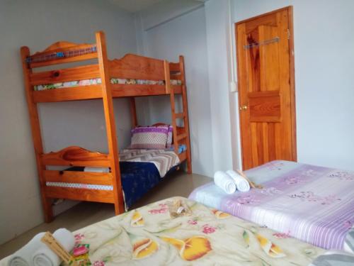a bedroom with two bunk beds and a bed at SOLEIL de SAGADA INN in Sagada