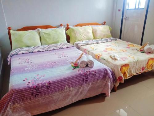 two beds sitting next to each other in a bedroom at SOLEIL de SAGADA INN in Sagada