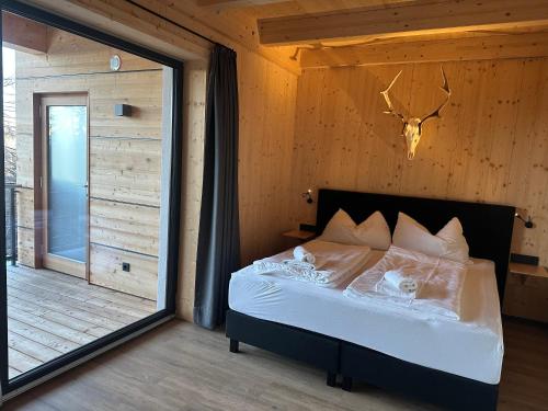 a bedroom with a bed with a large mirror at Chalet-Style Apartment Sonnleitn Nassfeld in Hermagor