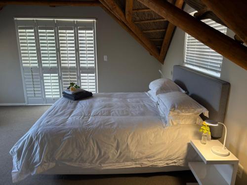 a bedroom with a large bed and a window at Jongensfontein Beachside Villa in Jongensfontein