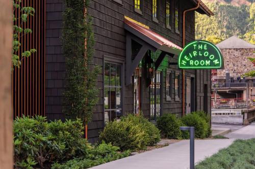 a green sign in front of a building at Historic Rocky Waters Inn, A Small Luxury Hotel in Gatlinburg