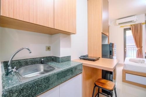 a kitchen with a sink and a counter top at Simply and Nice Studio at Transpark Cibubur Apartment By Travelio in Depok
