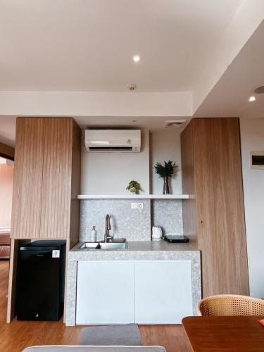 a kitchen with a sink and a counter at 3BR Apartemen Sudirman Bandung in Bandung