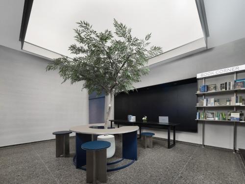 a tree sitting on a table in a library at Atour Light Hotel Xi'an Jingkai North Railyway Station in Xi'an