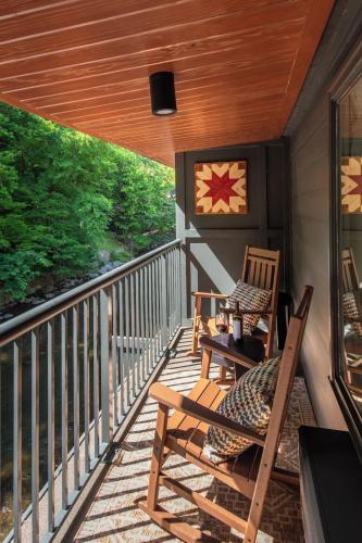 a porch with two chairs and a table at Historic Rocky Waters Inn, A Small Luxury Hotel in Gatlinburg