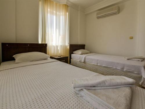 Ένα ή περισσότερα κρεβάτια σε δωμάτιο στο SUNSET BEACH CLUB LEBRENTALS