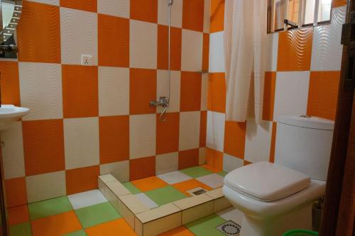 a colorful bathroom with a toilet and a sink at KIGALI FANTASTIC APARTMENT airport Road in Kigali
