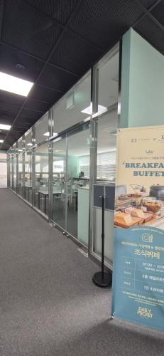 an empty office building with a large wall of windows at Elmomento Sasang in Busan