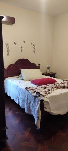 a bedroom with a large bed with a wooden headboard at casa na Torre in Machico