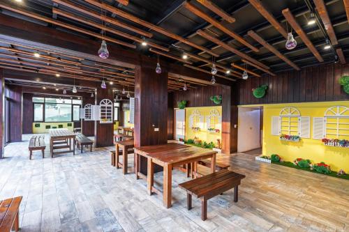 a dining room with wooden tables and benches at 17 Happiness in Xiaoliuqiu