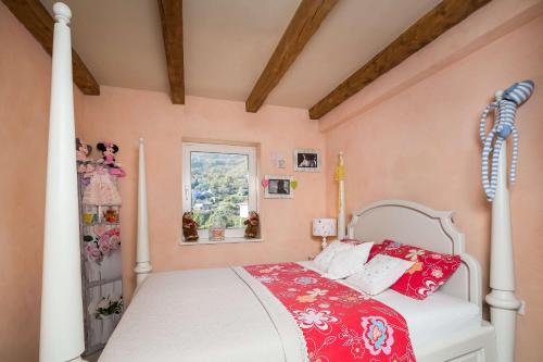 a bedroom with a bed with red and white pillows at Villa Stonegate Estate - Bonus, dvije vile jedna cijena! in Opatija