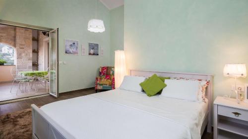 a bedroom with a large white bed with green pillows at Villa Stonegate Estate - Bonus, dvije vile jedna cijena! in Opatija