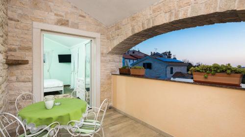a room with a table and chairs on a balcony at Villa Stonegate Estate - Bonus, dvije vile jedna cijena! in Opatija