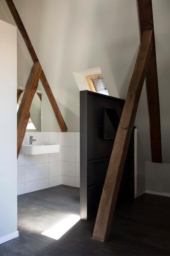 an attic bathroom with a sink and a counter at Kötterhof Hotel in Herdecke