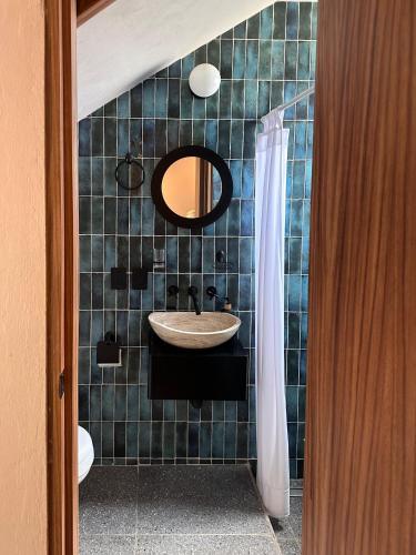 a bathroom with a sink and a mirror at Casa Tonalli in Jocotepec