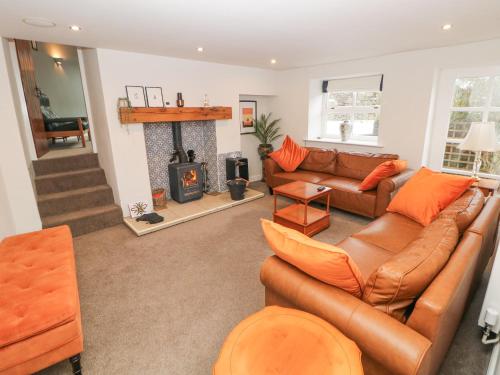a living room with a couch and a fireplace at Homestead in Chapel en le Frith