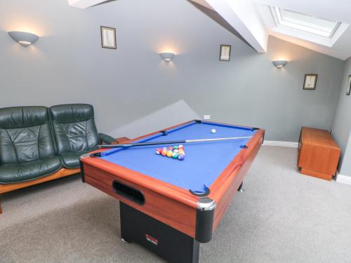 a room with a pool table and a couch at Homestead in Chapel en le Frith