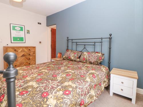 a bedroom with a bed and a wooden dresser at Homestead in Chapel en le Frith