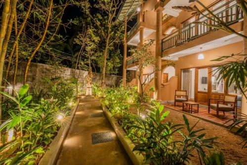 a garden with plants and lights in a building at Aurora in Unawatuna