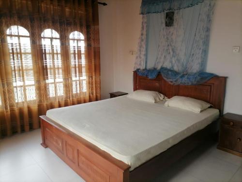 Ένα ή περισσότερα κρεβάτια σε δωμάτιο στο Bliss House