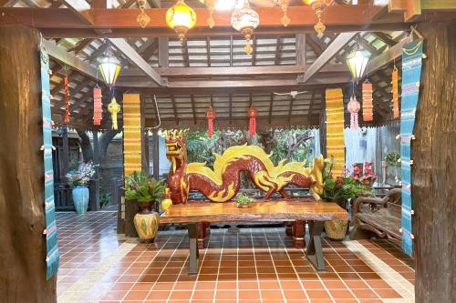 a wooden bench in a room with flowers and lights at Chiangmai Lanna & Modern Loft Hotel in Ban Mae Pu Kha