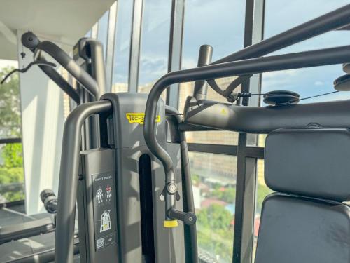 a gym with a treadmill and a seat and a window at Panoramic Georgetown City & Sea View with Netflix in Jelutong