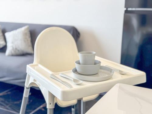 a white tray with a cup and a plate on it at Panoramic Georgetown City & Sea View with Netflix in Jelutong