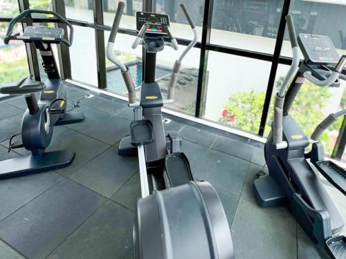 a row of cardio machines in a gym at Panoramic Georgetown City & Sea View with Netflix in Jelutong