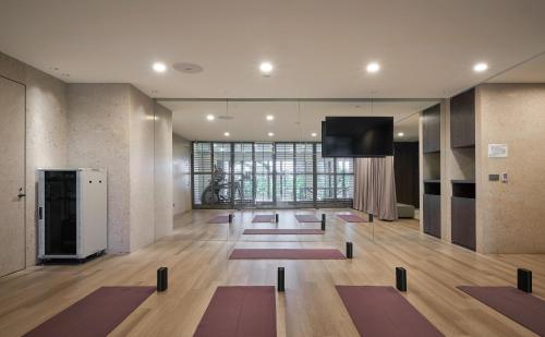 a yoga room with mats on the floor and a flat screen tv at Hotel Royal Beitou in Taipei