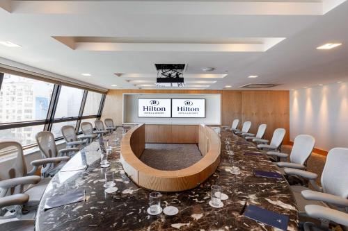 a conference room with a long table and chairs at Hilton Copacabana Rio de Janeiro in Rio de Janeiro