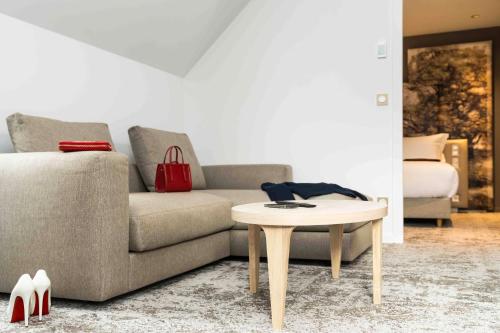 a living room with a couch and a table at Dolce by Wyndham Versailles - Domaine du Montcel in Jouy-en-Josas