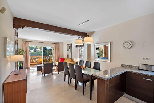 a kitchen and dining room with a table and chairs at Wyndham Grand Costa del Sol in Mijas Costa