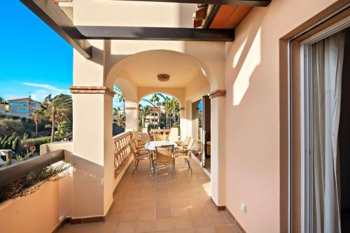 a balcony of a house with a table and chairs at Wyndham Grand Costa del Sol in Mijas Costa