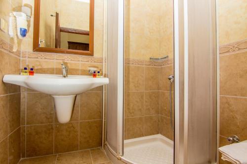 a bathroom with a sink and a shower at Hotel Karbel Sun in Oludeniz