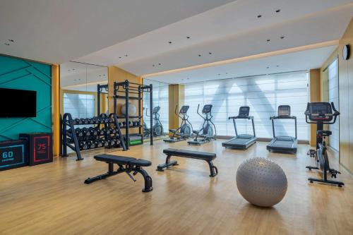 a gym with exercise bikes and a ball in the middle at Hilton Garden Inn Foshan Lishui-Free Shuttle Bus for Canton Fair in Foshan