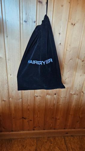a black bag hanging on a wooden wall at Árnanes Country Hotel in Höfn
