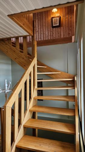 a staircase in a house with wooden rails at Árnanes Country Hotel in Höfn