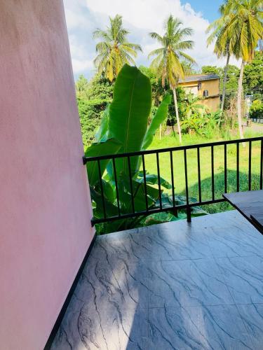 a balcony with a chair and a fence at Malinga homes in Wennappuwa
