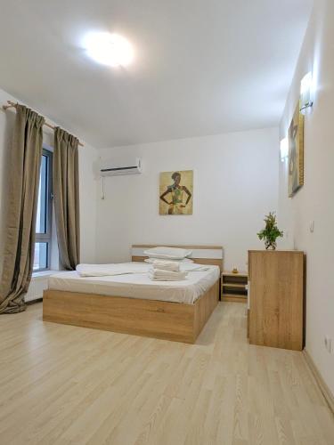 a bedroom with a large bed in a room at Sea View 3-Room Apartment in Olimp