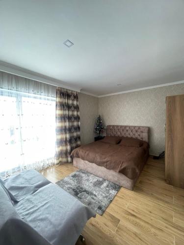 a bedroom with two beds and a window at Marni's cottage in Bakuriani in Bakuriani