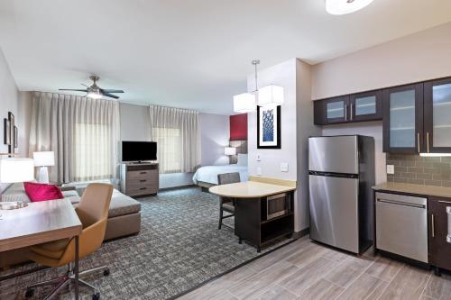 a hotel room with a kitchen and a living room at Staybridge Suites - Houston IAH Airport East by IHG in Humble