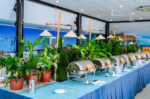 a table with a bunch of potted plants on it at Silver Beach Resort Ke Ga in Ke Ga