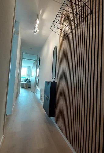 a hallway of a house with a wooden wall at Badhotel Appartementen Callantsoog in Callantsoog