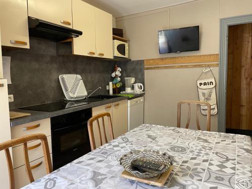 une cuisine avec une table avec une assiette dessus dans l'établissement B9 villa MASSIAS, à La Bourboule