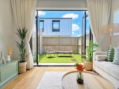 a living room with a couch and a table at Central Oasis Hideaway - Aircon 2-BR VS Backyard Close to Ponsonby in Auckland