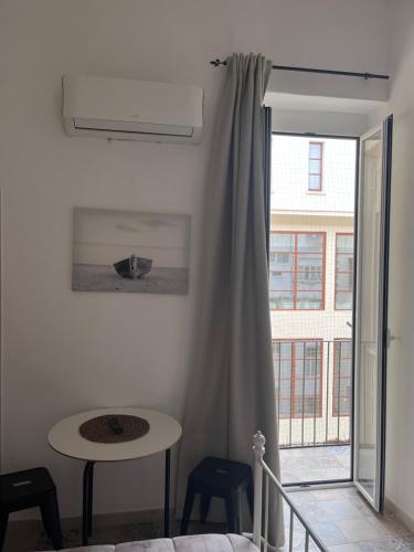 a white room with a table and a window at Whiteflower Apartments in Bari