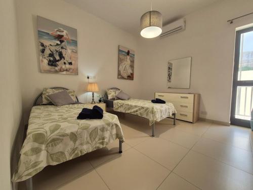 Postel nebo postele na pokoji v ubytování ICC Holiday apartment in Marsascala