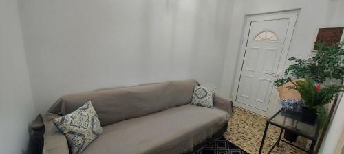 a living room with a couch and a door at Airport Friendly House 4 in Artemida